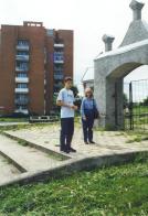 Picture of the gate of the Jewish cemetery of Slonim and a near by apartment block